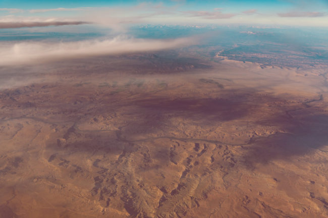 Falling Up by Mako Miyamoto clouds sky blue flight travel mountains photography desert