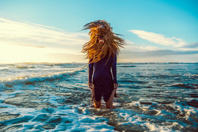 Photograph by Mako Miyamoto. Wookie standing in the ocean waves in oregon shaking her hair in the golden glow of the sun